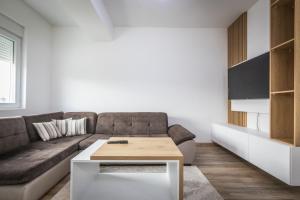 a living room with a couch and a table at Sofija Apartments in Gevgelija