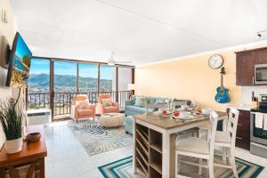 a kitchen and living room with a table and chairs at Panoramic Mountain View Near Waikiki Beach with Parking in Honolulu