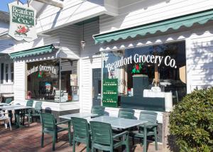 a restaurant with tables and chairs in front of a store at Beaufort Harbour Suites West Lodge in Beaufort +17 photos