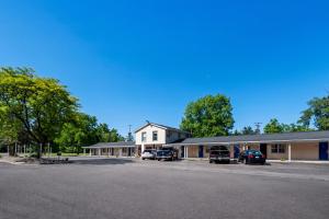 a building with cars parked in a parking lot at Americas Best Value Inn Jonesville/Hillsdale in Jonesville