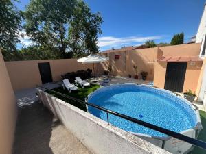 a swimming pool on the side of a house at La Alameda in Fontiveros