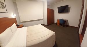 A bed or beds in a room at HOTEL Javier Prado Inn