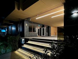 a lobby with stairs and a building with lights at AMB Residence Luxury Pipera in Voluntari