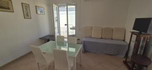 a room with a table and a bed and a television at Casa Giusto Ischia 3 in Ischia Town