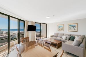 a living room with a couch and a table at San Simeon 33 in Gold Coast