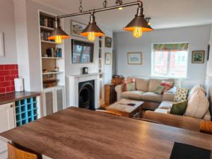 a kitchen and living room with a wooden table at Avro in Southampton