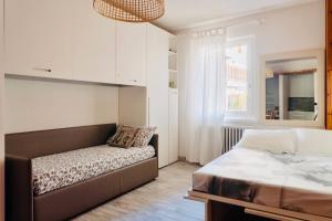 A bed or beds in a room at Gloria Holiday Home Bormio