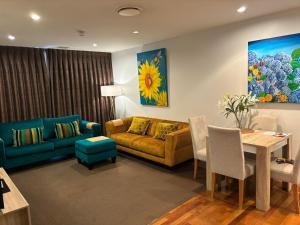 a living room with a couch and a table at Museum Apartment in Wellington