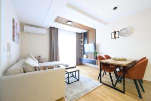 a living room with a couch and a table at Apartman North resort in Vrnjačka Banja