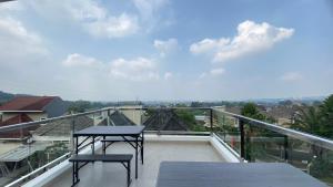 a balcony with a table and two chairs on it at Eben Haezer Villas in Karangploso