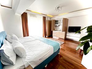 a bedroom with a large bed and a television at Luna Studio White Tower in Mamaia +8 photos