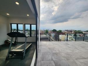 a balcony with a treadmill and a view of the city at New Modern 2BR Apartment - minutes to NYC in Bayonne