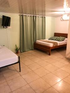 Postel nebo postele na pokoji v ubytování Hostal Síndigo