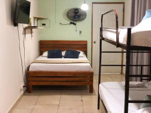 Postel nebo postele na pokoji v ubytování Hostal Síndigo