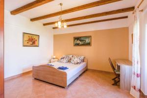 a bedroom with a bed and a desk in a room at Apartment in Bribir 41909 in Bribir
