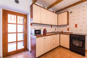 a kitchen with a sink and a microwave at Apartment in Bribir 41909 in Bribir