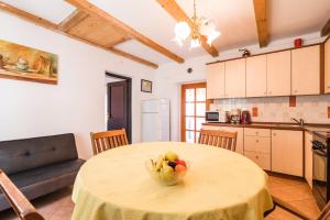 a kitchen with a table with a bowl of fruit on it at Apartment in Bribir 41909 in Bribir +12 photos