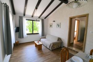 a living room with a couch and a table at Holiday home in Moscenicka Draga 43083 in Kraj