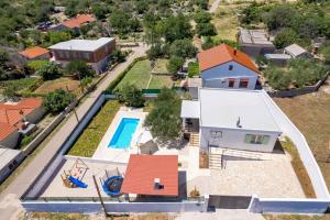 an aerial view of a house with a swimming pool at Holiday home in Slivnica - Paklenica Riviera 44875 in Slivnica