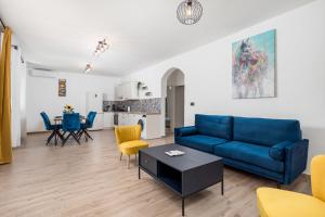 a living room with a blue couch and a table at Holiday home in Slivnica - Paklenica Riviera 44875 in Slivnica