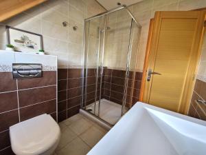 a bathroom with a shower and a toilet and a sink at Modern House in Brittany near La Baule Bay in Pénestin