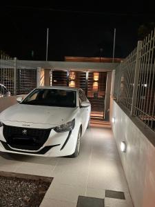 a white car parked in a garage at night at Laguna Pampa in Chascomús