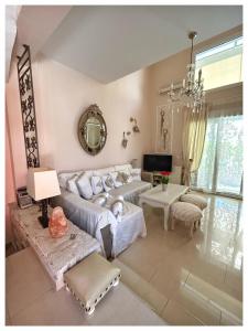 a living room with a couch and a table at villa MeDITeRAN in Pefkohori