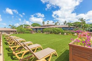 a row of chairs on a lawn in front of a building at Maui Eldorado - L-105 - in Kahana