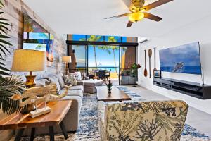 a living room with a couch and a table at Kahana Villas - F508 - in Kahana