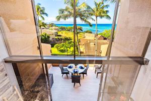 a room with a view of the ocean and palm trees at Kahana Villas - F508 - in Kahana