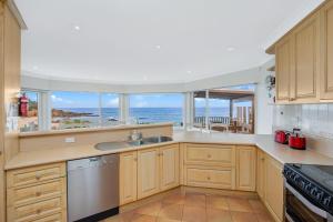 a kitchen with a view of the ocean at 3 Dickinson Avenue in Bermagui