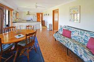 a living room with a table and a couch at 4 Callow in Bermagui