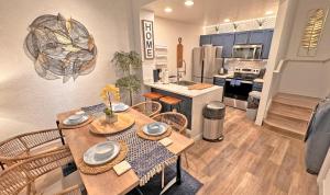 a kitchen and dining room with a table and chairs at Villas at Seven Dwarfs Resort - Near to Disney in Kissimmee