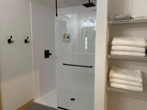 a glass shower in a bathroom with towels at Bearded Buffalo Resort in Custer +57 photos