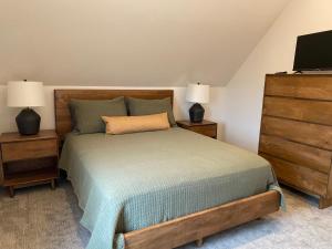 a bedroom with a bed and two night stands at Bearded Buffalo Resort in Custer