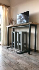 a console table with a television on top of it at CasaSur- 37Robles in Villa La Angostura
