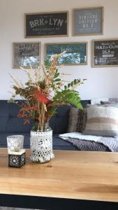 a vase with flowers on a table in a living room at CasaSur- 37Robles in Villa La Angostura +24 photos