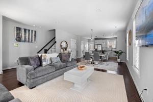 a living room with a couch and a table at Downtown Richmond, Cozy 3BR, Near VCU in Richmond