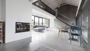 a living room with a couch and a table and chairs at Kalaranna Holiday Home in Eisma