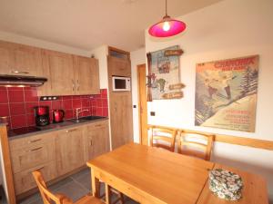 a kitchen with a wooden table and a dining room at Studio cabine rénové 4 pers avec garage, Les Saisies - FR-1-293-180 in Les Saisies