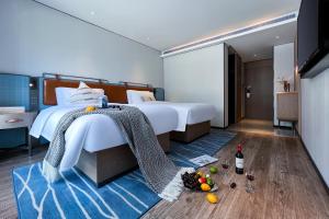 Postel nebo postele na pokoji v ubytování Echarm Hotel Guangzhou Dongpu Financial City Pazhou Convention Center - Free shuttle bus for Canton Fair
