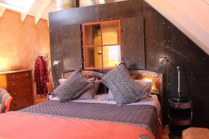 a bedroom with a large bed with a black headboard at Arty Luxury Barn Apartment in Closeburn +23 photos