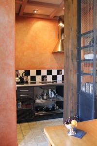 a kitchen with a stove and a counter top at Arty Luxury Barn Apartment in Closeburn