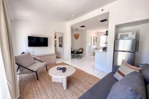 a living room with a couch and a table at Shaomi South Beach in Miami Beach