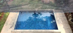 an overhead view of a pool with blue water at Villa Kayu Unique with private pool in Babagan