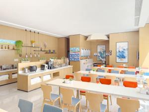 a restaurant with tables and chairs and a cafeteria at Holiday Inn Express Zhangye by IHG in Zhangye