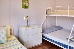 a bedroom with two bunk beds and a nightstand at 81 Murrah in Bermagui