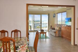 a living room with a table and a couch at 81 Murrah in Bermagui