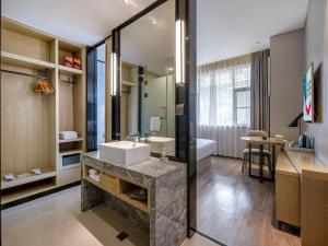 a bathroom with a sink and a mirror at Echarm Hotel Nanning the MixC Exhibition Center Metro Station in Nanning +33 photos