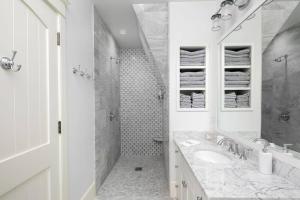 a white bathroom with a sink and a shower at The Beachfront Estate, 360 Ocean Views, 5700 sqft in Mattapoisett +55 photos
